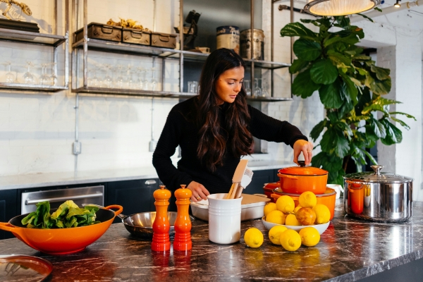 Woman preparing food on counter top - Home Remodeling - Rogers Kitchens